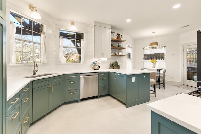 kitchen featuring green cabinetry, dishwasher, a peninsula, and a sink