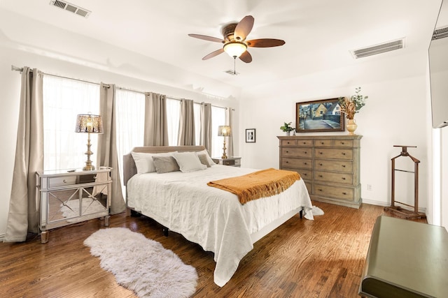 bedroom featuring multiple windows, visible vents, and wood finished floors