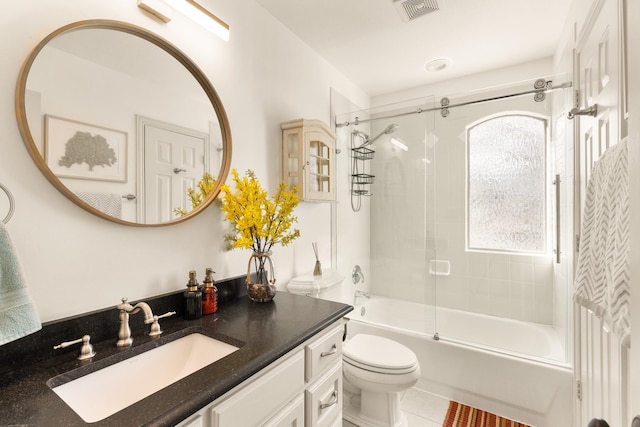 full bath with visible vents, toilet, combined bath / shower with glass door, vanity, and tile patterned flooring