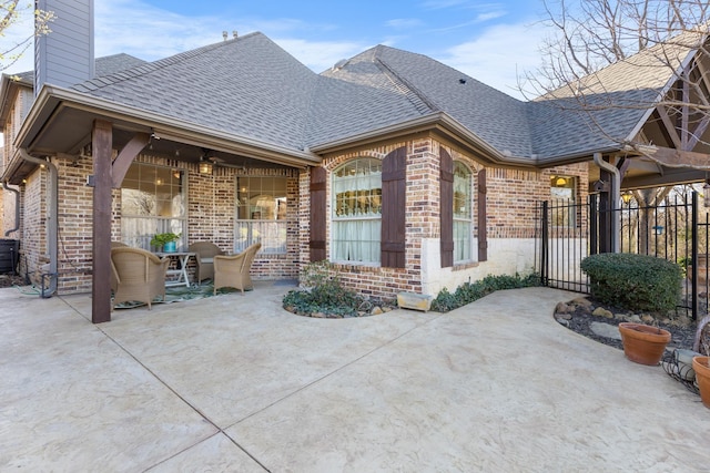 view of patio featuring a ceiling fan, a gate, and fence