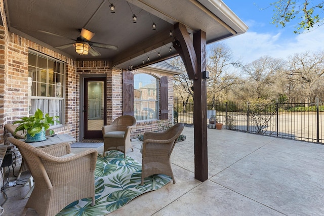 view of patio / terrace featuring ceiling fan and fence