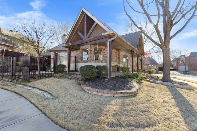 view of front of home featuring brick siding, a chimney, a shingled roof, and fence