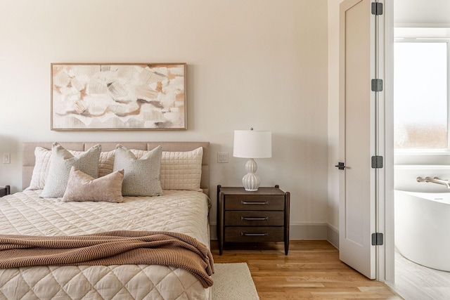 bedroom featuring light wood-style flooring and baseboards