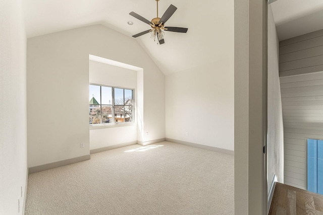 additional living space featuring carpet floors, ceiling fan, baseboards, and vaulted ceiling