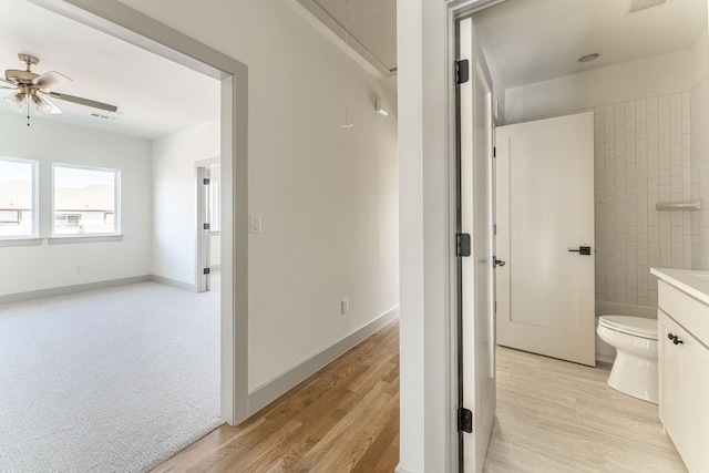 full bathroom featuring baseboards, visible vents, toilet, ceiling fan, and wood finished floors