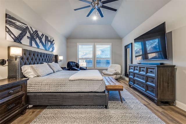 bedroom with lofted ceiling, ceiling fan, baseboards, and wood finished floors