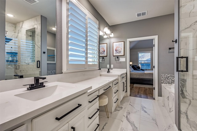 ensuite bathroom with double vanity, a stall shower, a sink, and visible vents