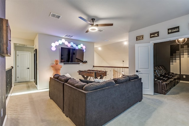 living room with ceiling fan, visible vents, and light colored carpet