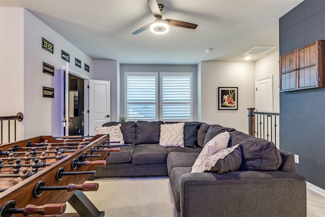 carpeted living room with visible vents, ceiling fan, and baseboards