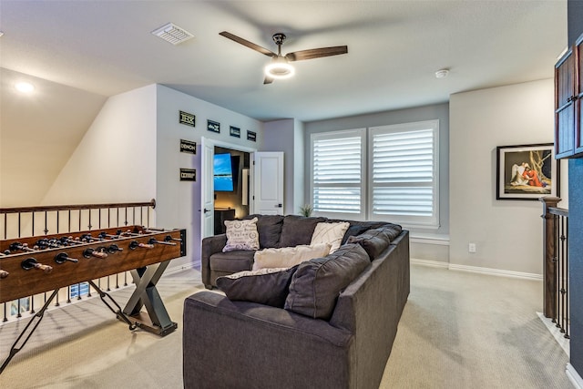 living area with baseboards, a ceiling fan, visible vents, and light colored carpet