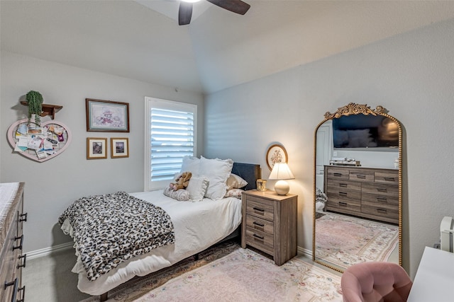 bedroom with lofted ceiling, ceiling fan, and baseboards