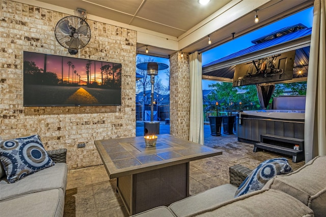 view of patio / terrace with outdoor dining space and a hot tub