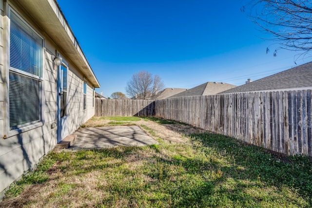 view of yard with a patio area and a fenced backyard