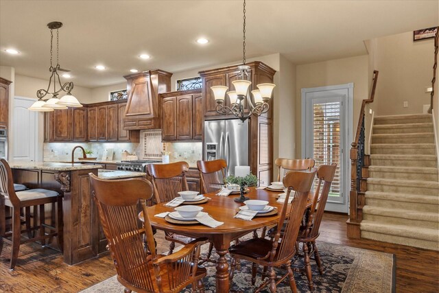dining room featuring plenty of natural light, dark wood finished floors, stairway, a chandelier, and recessed lighting