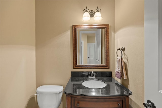 bathroom featuring toilet and vanity