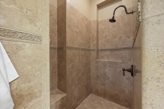 bathroom with a tile shower