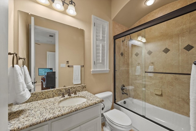 full bath featuring enclosed tub / shower combo, toilet, and vanity