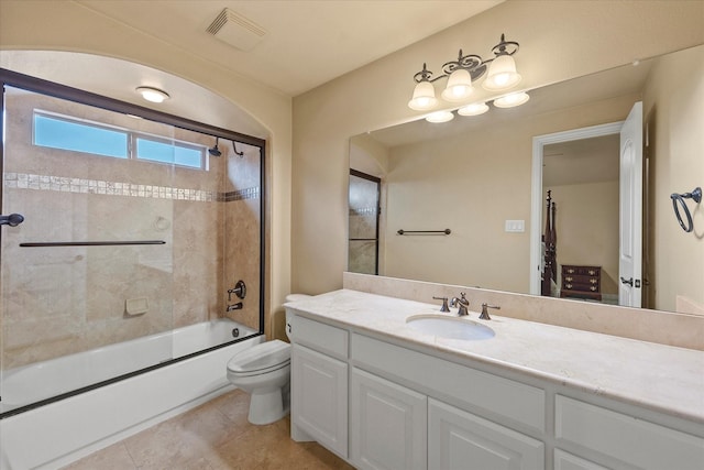 bathroom with toilet, bath / shower combo with glass door, vanity, visible vents, and tile patterned floors