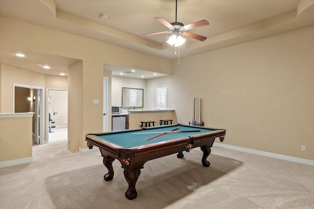 recreation room with a raised ceiling, light carpet, ceiling fan, billiards, and baseboards