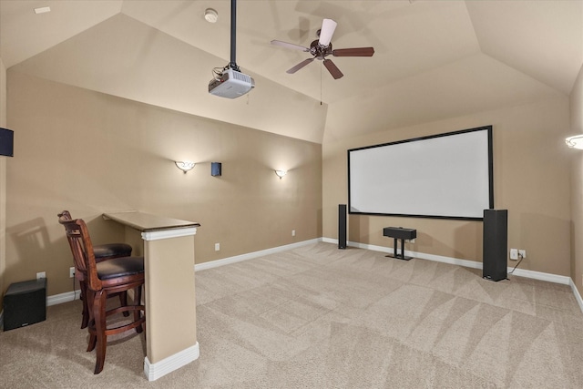 carpeted home theater room with baseboards, a ceiling fan, and lofted ceiling