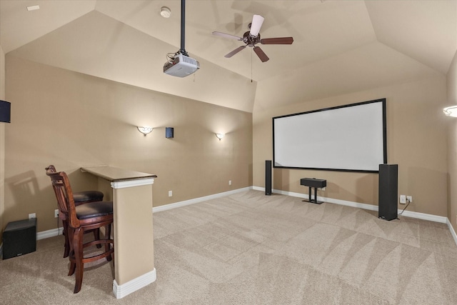 cinema with vaulted ceiling, carpet floors, a ceiling fan, and baseboards