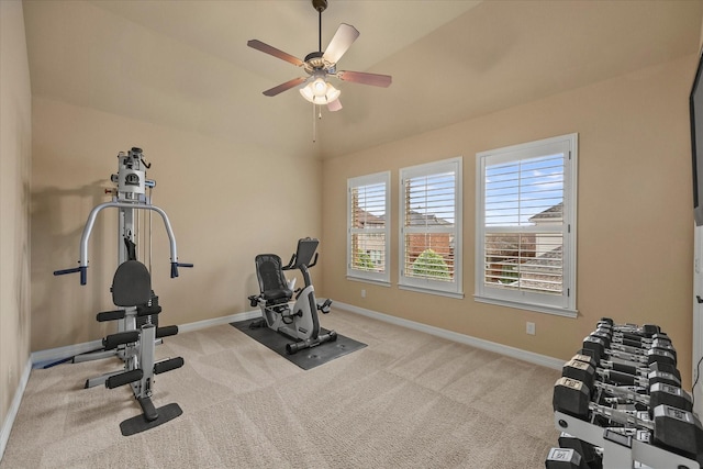 workout room with vaulted ceiling, baseboards, a ceiling fan, and carpet flooring