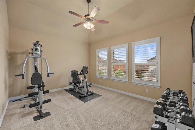 exercise room with ceiling fan, carpet floors, lofted ceiling, and baseboards