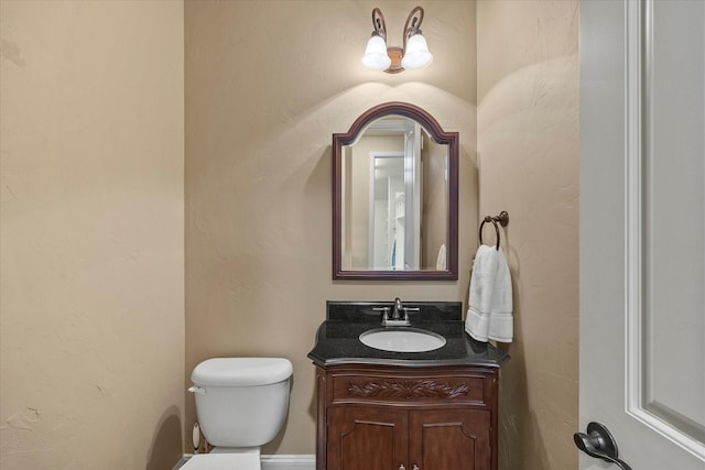 half bath featuring toilet and vanity