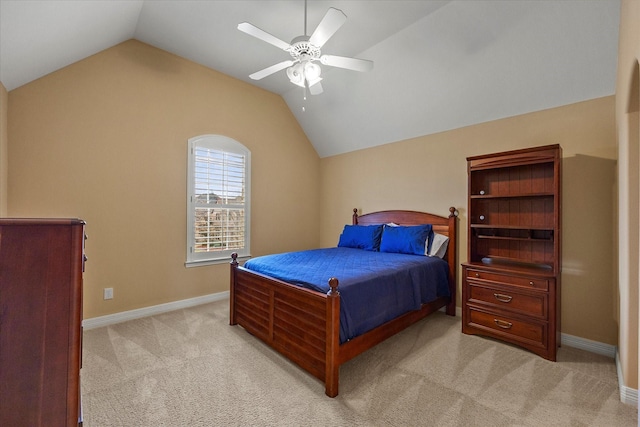 bedroom featuring light colored carpet, a ceiling fan, baseboards, and lofted ceiling
