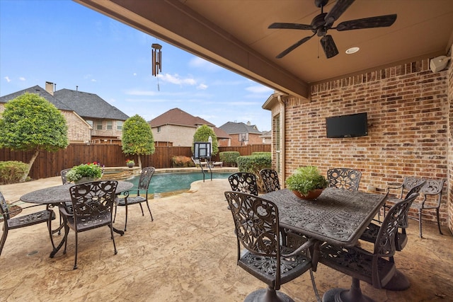 view of patio with ceiling fan, outdoor dining space, a fenced backyard, and a fenced in pool