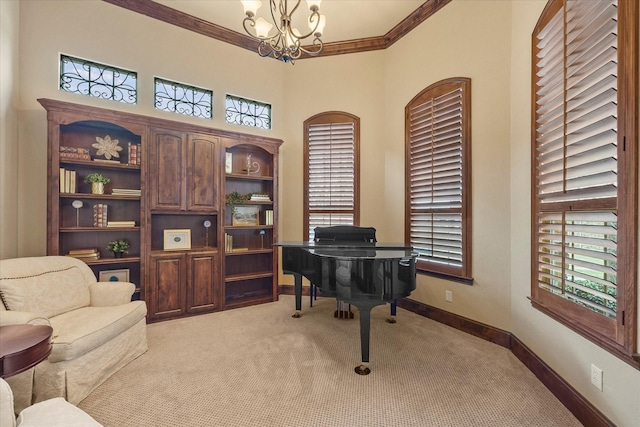sitting room with plenty of natural light, ornamental molding, light colored carpet, and a chandelier