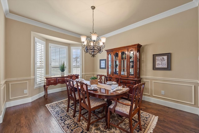 dining area with a chandelier, ornamental molding, and dark wood-type flooring