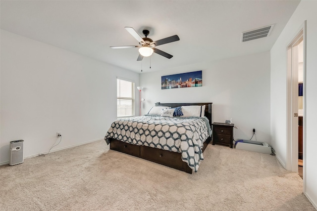 carpeted bedroom featuring ceiling fan, visible vents, and baseboards