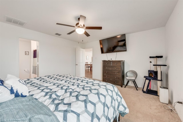 bedroom with visible vents, ceiling fan, and light carpet