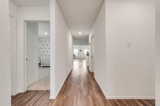 hall with wood finished floors and baseboards