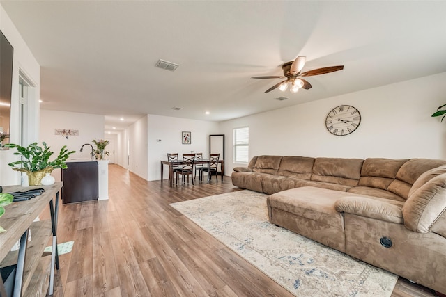 living area featuring recessed lighting, visible vents, ceiling fan, and light wood finished floors