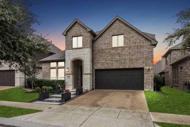 view of front of house with a garage, a front yard, brick siding, and driveway