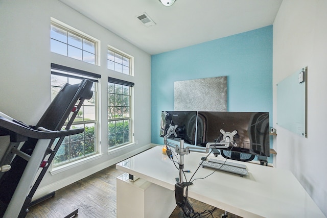 office featuring visible vents, baseboards, and wood finished floors