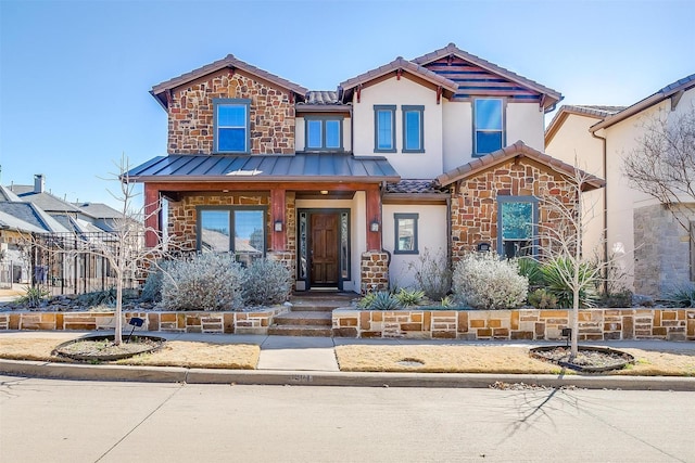 view of front of house with stone siding, a tile roof, a standing seam roof, and stucco siding