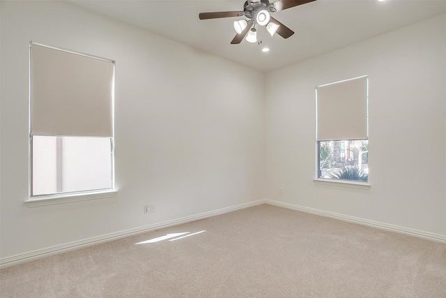 empty room featuring carpet floors, recessed lighting, and baseboards