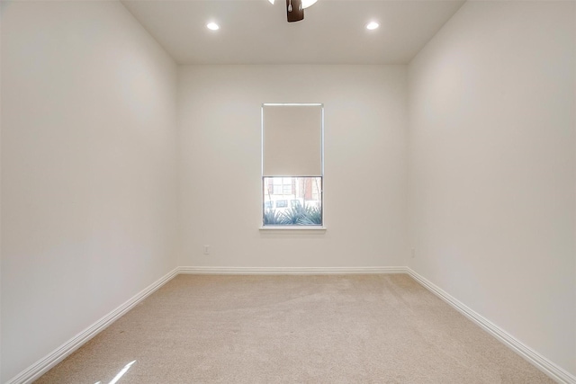 unfurnished room featuring recessed lighting, light colored carpet, ceiling fan, and baseboards