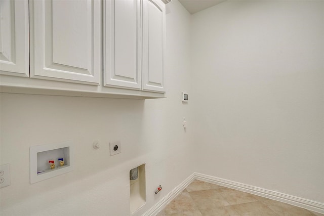 washroom featuring gas dryer hookup, hookup for an electric dryer, washer hookup, baseboards, and cabinet space