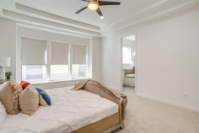 bedroom with light carpet, baseboards, and ensuite bathroom