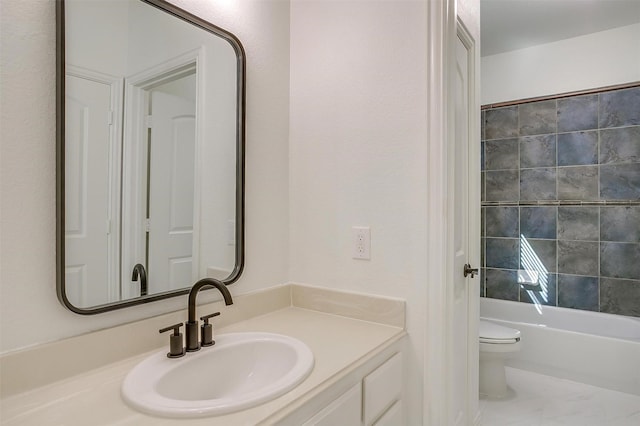 bathroom with toilet, a tub to relax in, and vanity