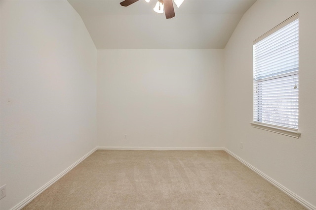 unfurnished room featuring lofted ceiling, light carpet, ceiling fan, and baseboards