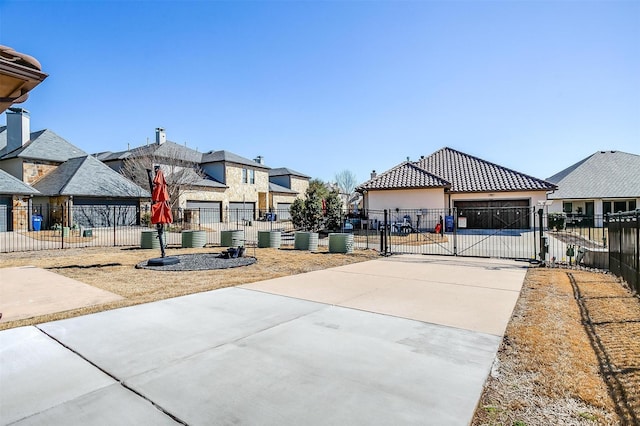 exterior space with a gate, driveway, and a gated entry