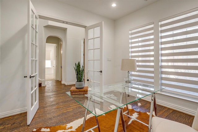 office space with arched walkways, french doors, recessed lighting, wood finished floors, and baseboards