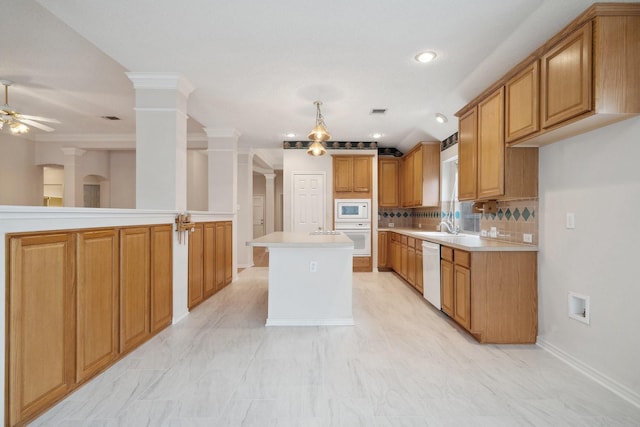 kitchen featuring ceiling fan, light countertops, white appliances, and decorative columns