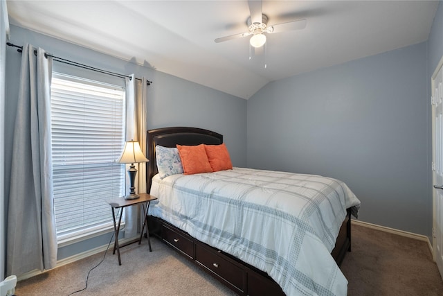 bedroom with light carpet, ceiling fan, baseboards, and vaulted ceiling