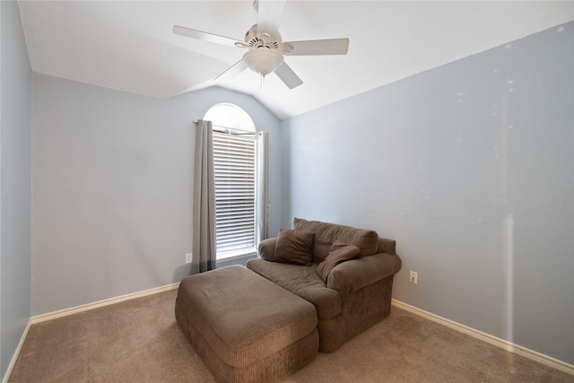 living area with a ceiling fan, carpet flooring, vaulted ceiling, and baseboards